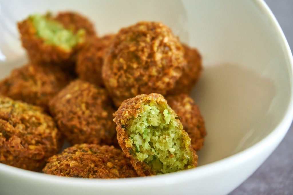 A bowl of cooked falafel balls is shown in this photo. 