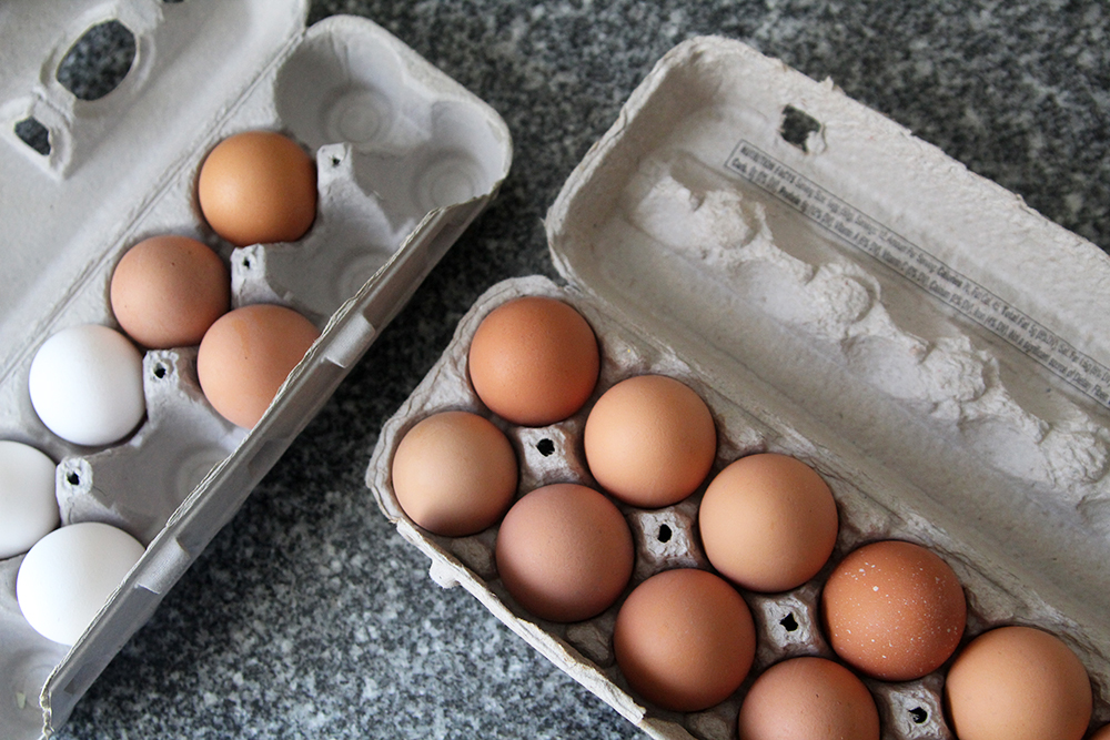 Two open cartons of eggs are shown on a countertop. 